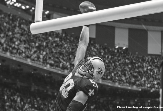 New Orleans Saints Tight End Jimmy Graham does his signature celebration, dunking over the goal post after a touchdown. His celebration has been banned by the NFL this season. 