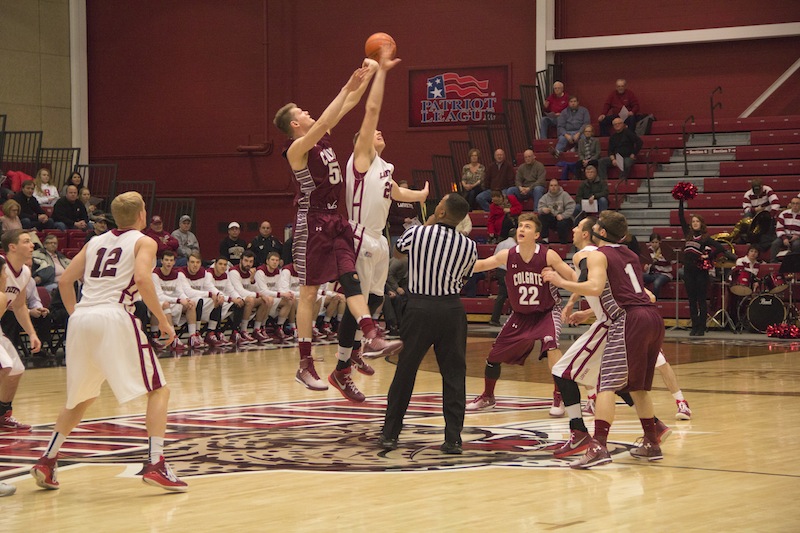 Senior Dan Trist meets the Colgate center at half court for tip-off [Photo by Christie Behot ‘16]